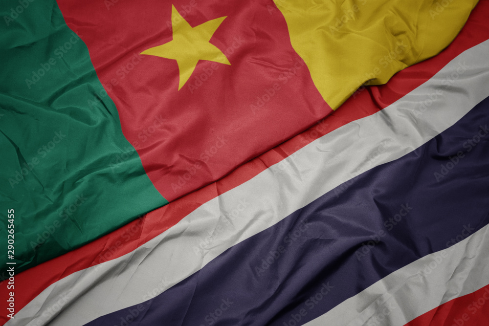 waving colorful flag of thailand and national flag of cameroon.