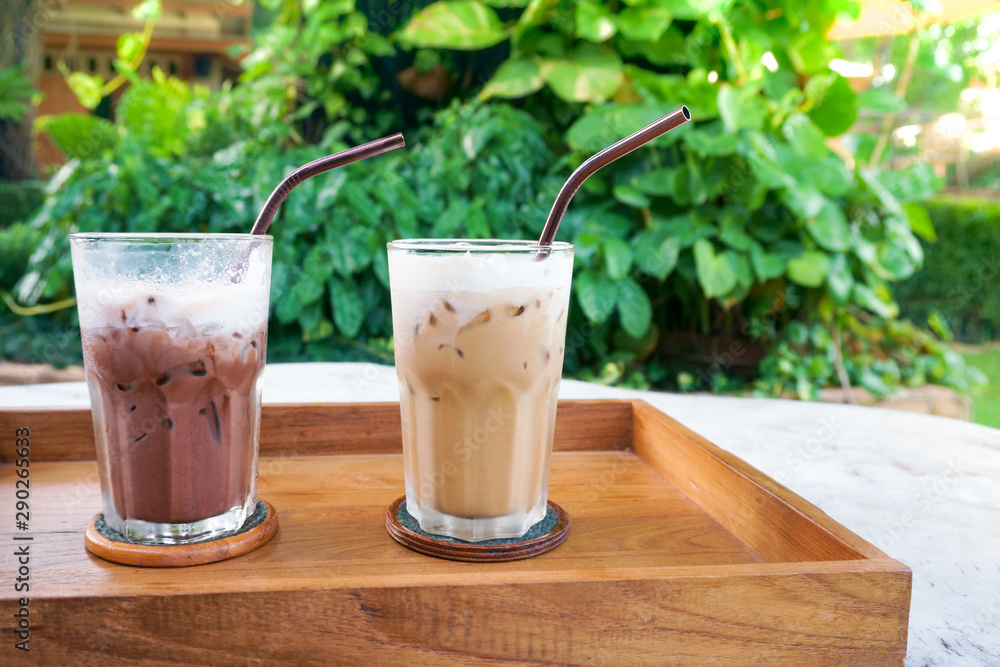 Glass Iced Coffee and Iced Cocoa on wood table green nature background,Iced latte coffee and Iced chocolate Glass Iced Coffee and Iced Cocoa on wood table green nature background,Iced latte coffee and Iced chocolate