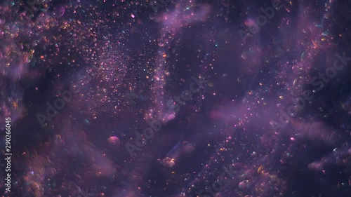 Streams full of tiny bokeh violet glittering bubbles are moving randomly and chaoticlally on the dark space background.