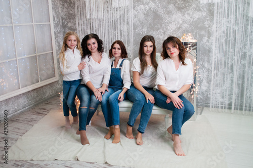 Company beautiful girls celebrating christmas, new year. Girls in the New Year's interior room