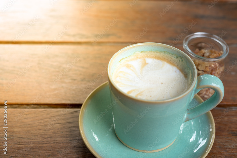Fototapeta premium Hot coffee latte and rock sugar brown on wood table.
