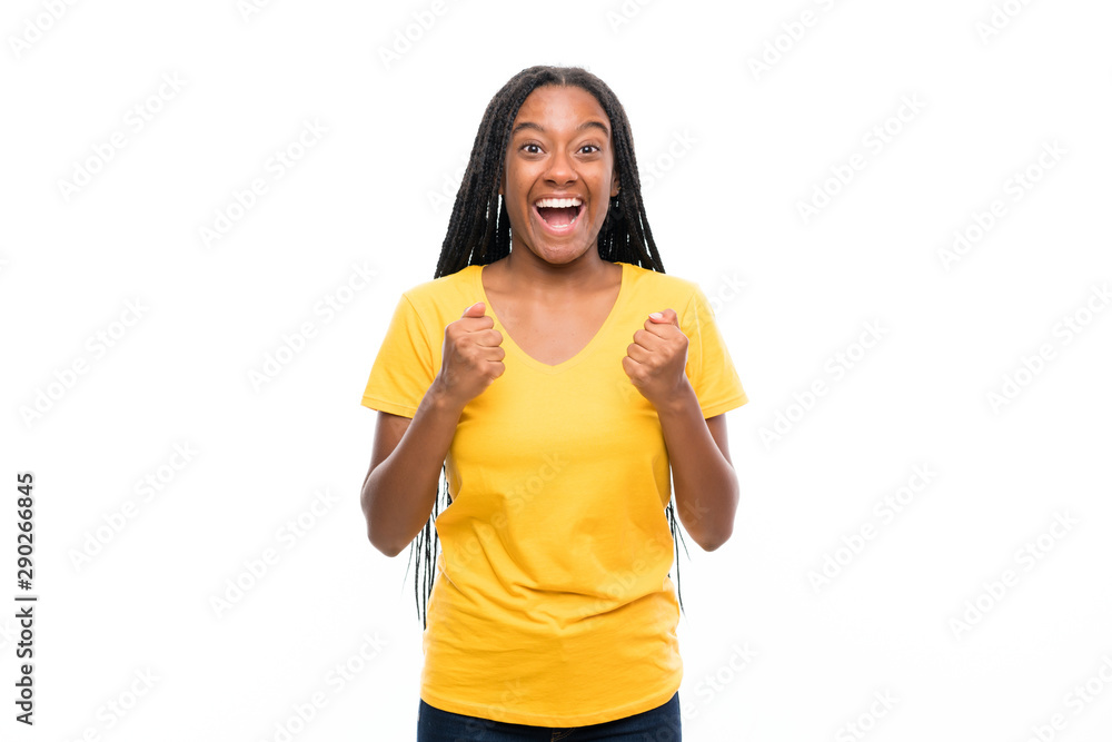 African American teenager girl with long braided hair over isolated white background celebrating a victory African American teenager girl with long braided hair over isolated white background celebrating a victory