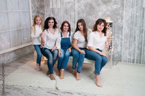 Company beautiful girls celebrating christmas, new year. Girls in the New Year's interior room