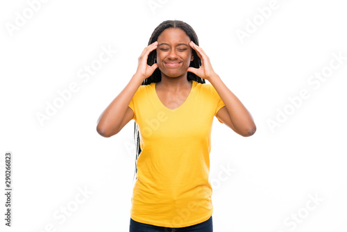 African American teenager girl with long braided hair over isolated white background unhappy and frustrated with something. Negative facial expression