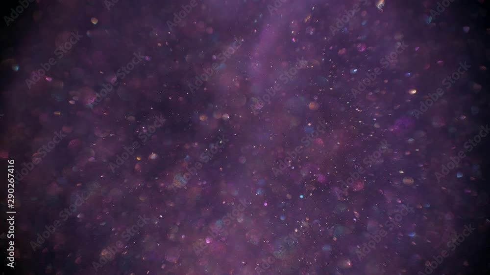 Nature dust raising up slowly on the violet background, blurred bokeh bubbles are glittering falling down on the forefront. Nature dust raising up slowly on the violet background, blurred bokeh bubbles are glittering falling down on the forefront.