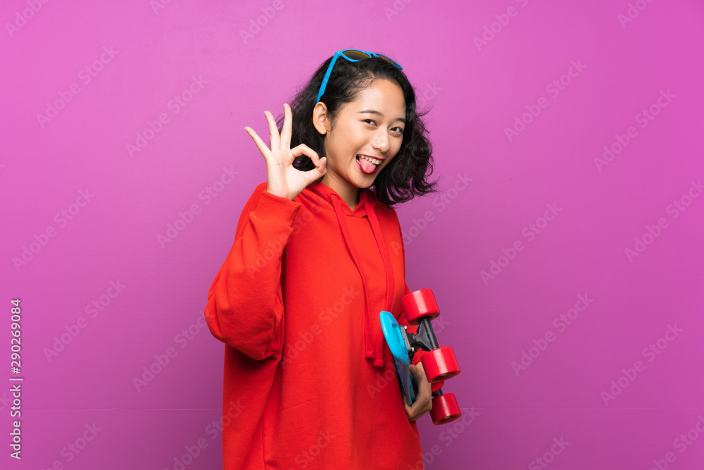 Asian young girl with skate over purple background Asian young girl with skate over purple background