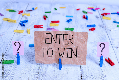 Text sign showing Enter To Win. Business photo text exchanging something value for prize chance winning prize Scribbled and crumbling sheet with paper clips placed on the wooden table