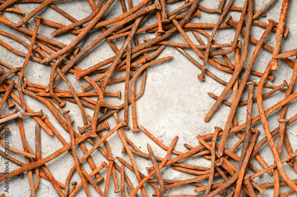 Fototapeta premium Rusty nails on a cement metal background