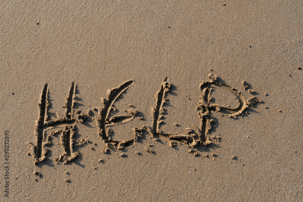 Fototapeta premium Help, written as a message on the sand