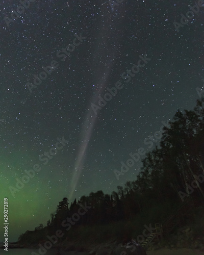 The atmospheric optical phenomenon known as STEVE (Strong Thermal Emission Velocity Enhancement), appears as a purple and green light ribbon in the sky in Manitoba, Canada photo