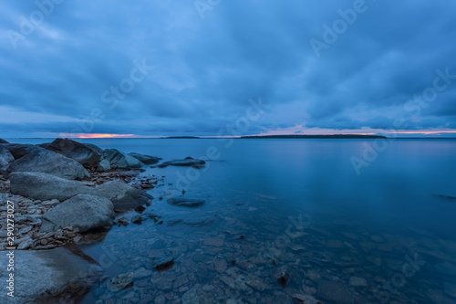 A cloudy day at the lakeside during blue hour with calm waters
