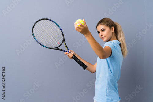 Teenager tennis player girl over grey wall © luismolinero