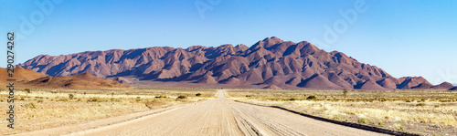 Gravel road leading into a mountainous landscape near Spreetshoogte Pass, Namibia