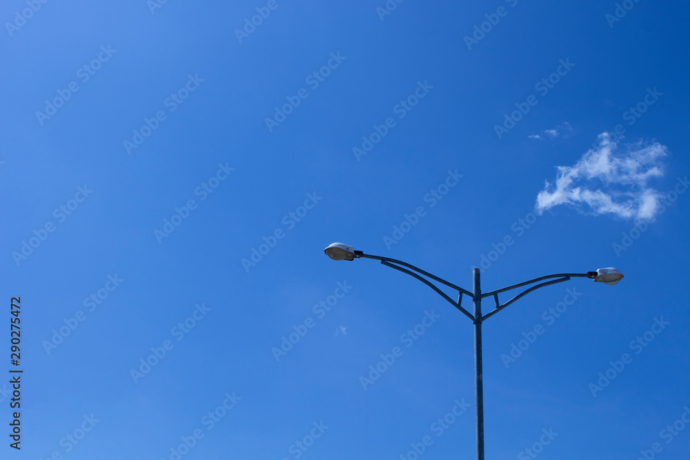 Electricity post stands alone (Street Lights) against the blue sky with clouds. copy space. Electricity post stands alone (Street Lights) against the blue sky with clouds. copy space.