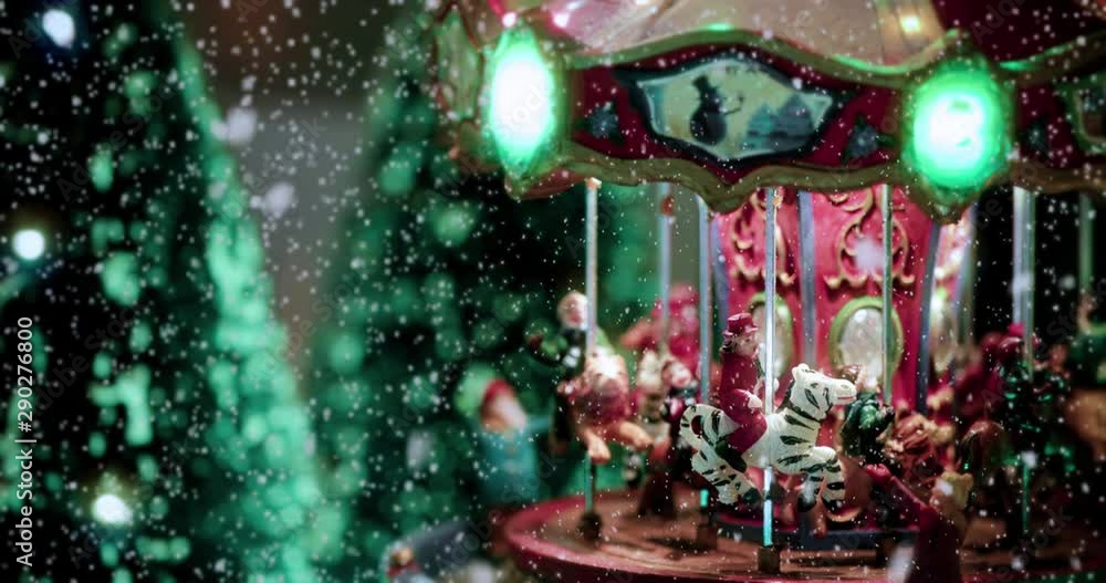 Christmas toy village scene ful of lights with a carousel toy, under the snow. Perfect decoration in store, for children at christmas holidays - close-up view - Christmas & event concept Christmas toy village scene ful of lights with a carousel toy, under the snow. Perfect decoration in store, for children at christmas holidays - close-up view - Christmas & event concept