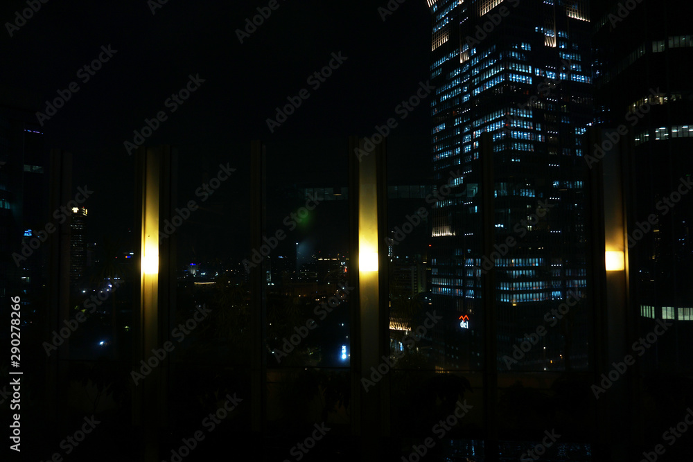 The light in the windows of an municipal building by night, darkness The light in the windows of an municipal building by night, darkness