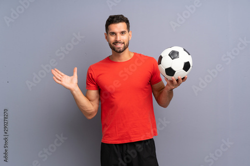 Handsome young football player man over isolated white wall with shocked facial expression © luismolinero