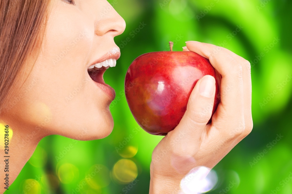 Young woman holding fresh apple on white background Young woman holding fresh apple on white background
