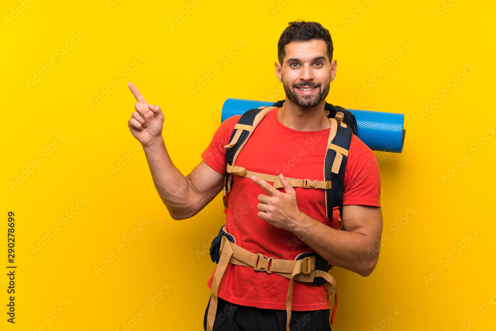 Young hiker man pointing finger to the side Young hiker man pointing finger to the side