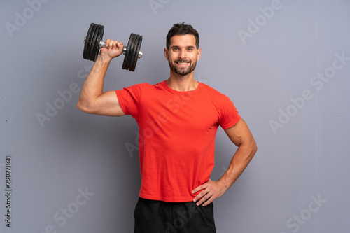 Young sport man making weightlifting