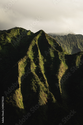 First rays of sunlight light up the beautiful and rugged green mountains of Oahu.