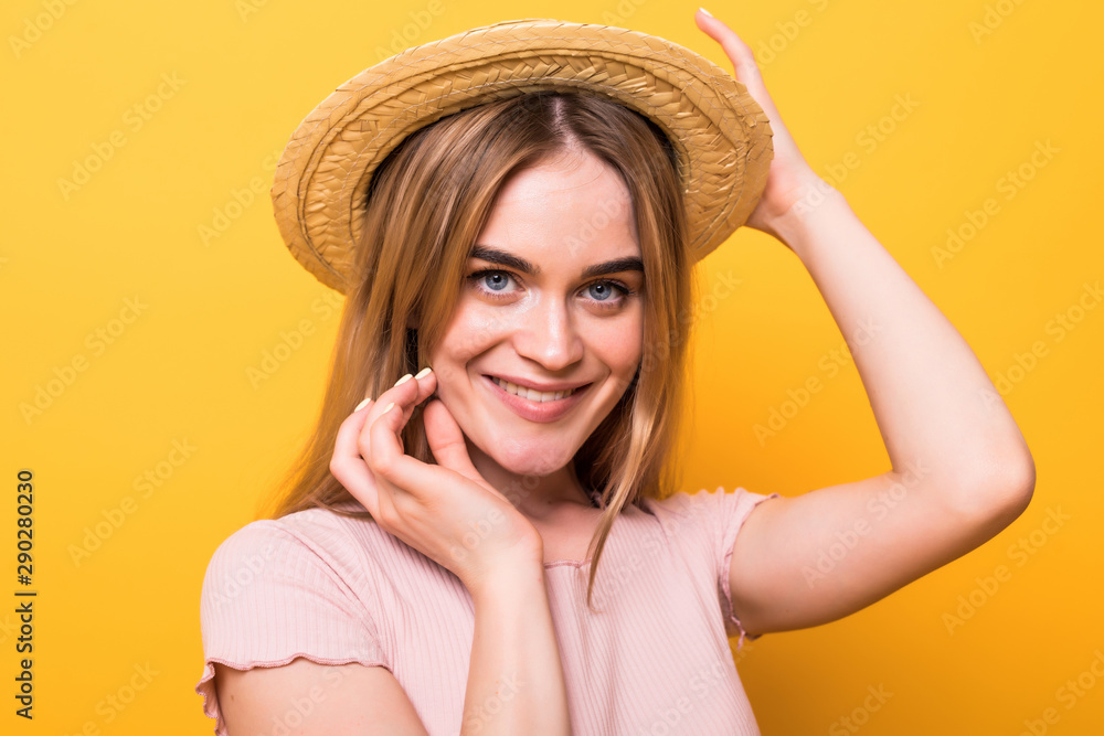 Hello, summer. Attractive young woman in swimwear isolated on orange background. Happy girl in pink sunglasses is posing with straw hat. Hello, summer. Attractive young woman in swimwear isolated on orange background. Happy girl in pink sunglasses is posing with straw hat.