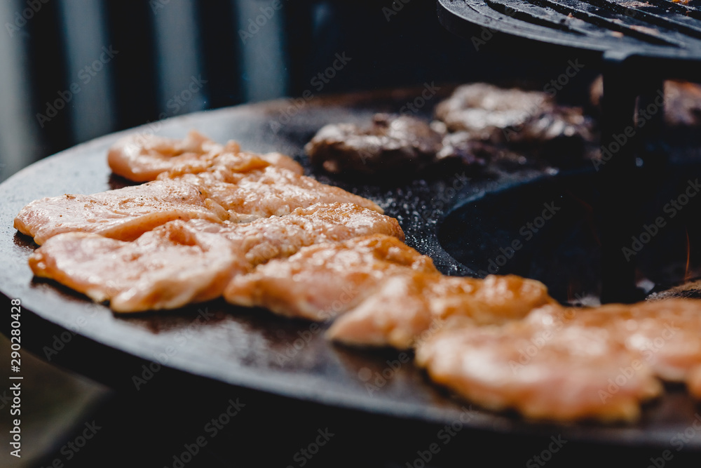 Pork ribs and steak cooked on grill, open fire street food festival Pork ribs and steak cooked on grill, open fire street food festival