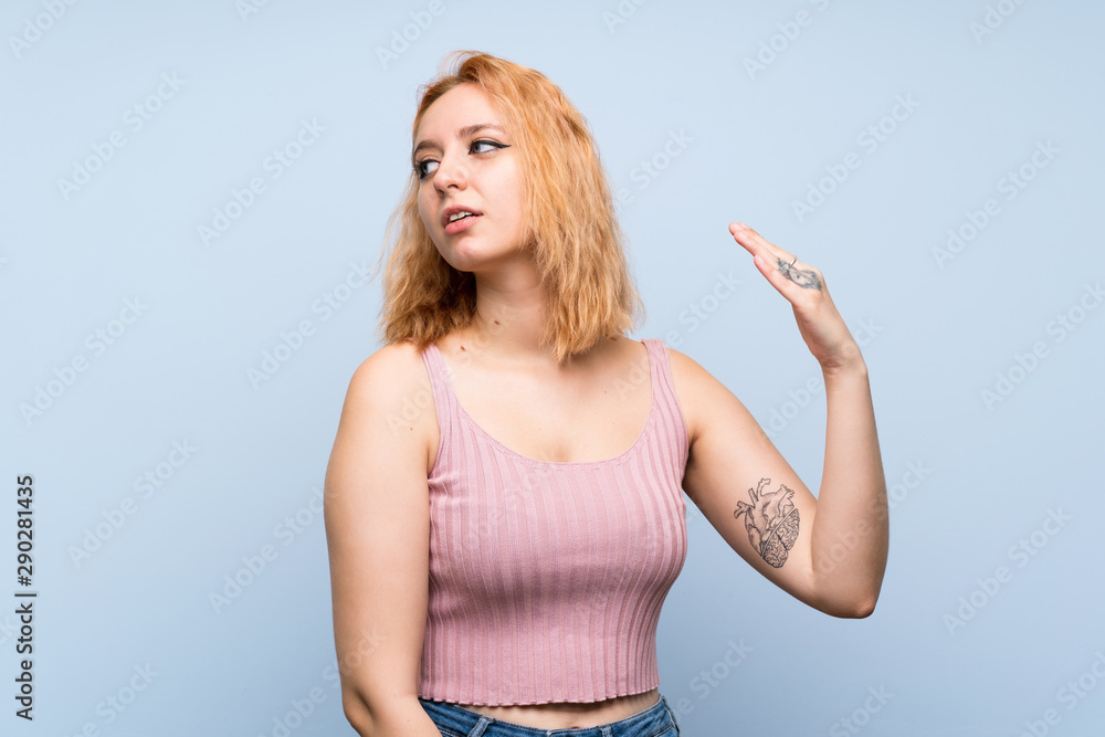 Young woman over isolated blue background with tired and sick expression Young woman over isolated blue background with tired and sick expression