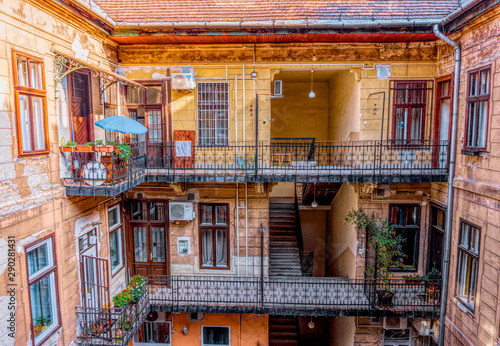 Canvas Print Budapest, Hungary -August 29, 2019: Staircase, forged railing and arched door in an old apartment building in Budapest, Hungary