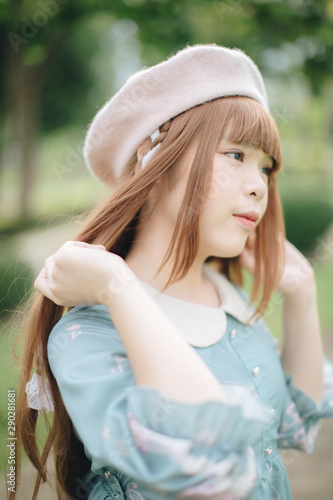 Canvas Print Portrait of asian girl in lolita fashion dress in garden background