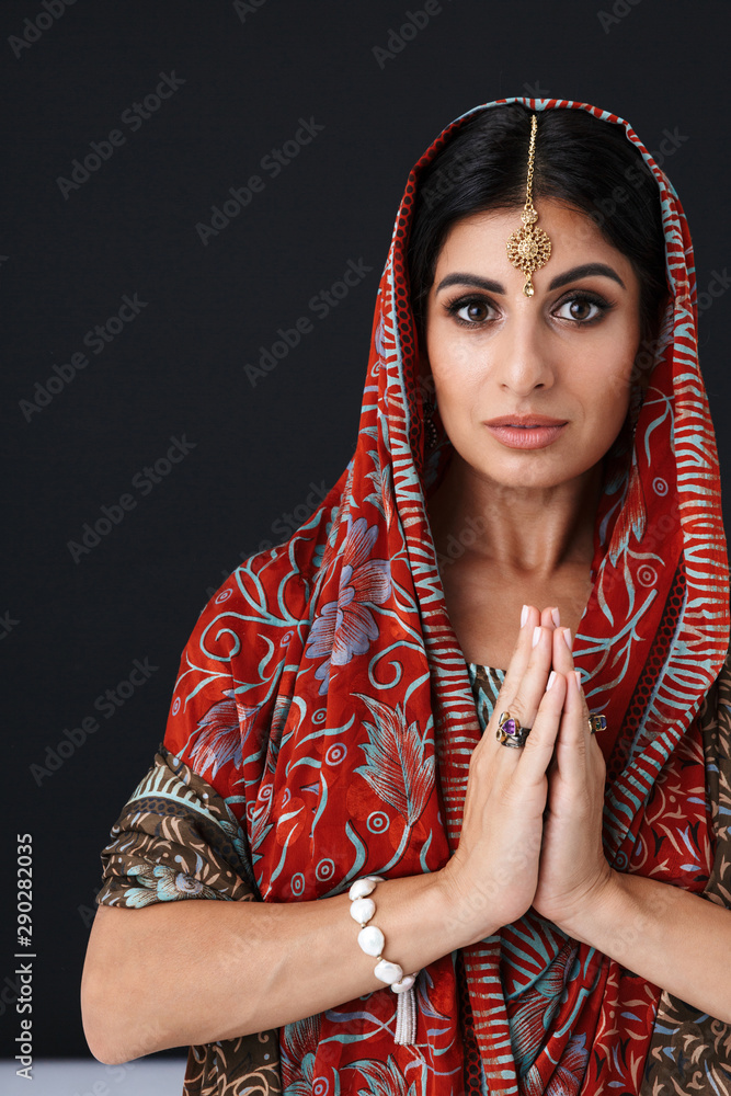Image of gorgeous hindus girl in traditional indian saree dress and jewelry dancing with palms together