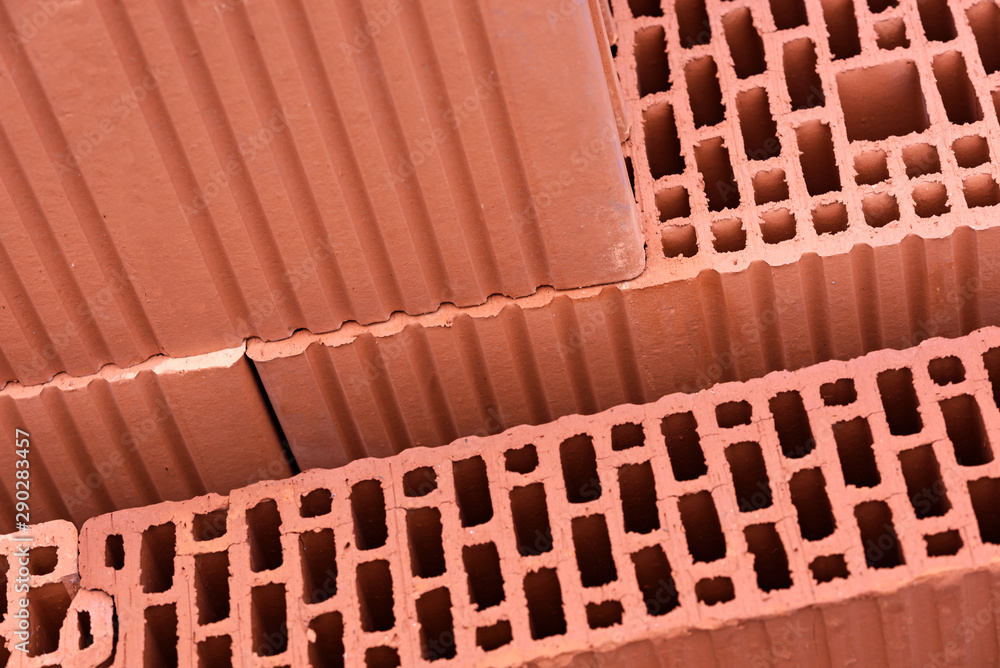 Modern construction industry concept - thermo isolated red bricks for building wall in close-up.