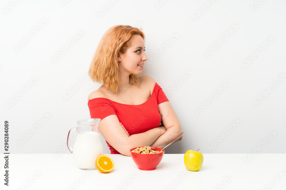 Young woman having breakfast looking to the side Young woman having breakfast looking to the side