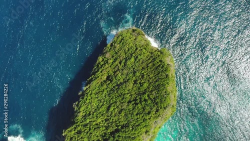 Beautifulbeach of Kelingking in Nusa Penid.    Drone Shot by drone Ocean with waves and rocky cliff Bali, Indonesia. Aerial view of Big Blue Sea Wave viewpoint. Top view photo