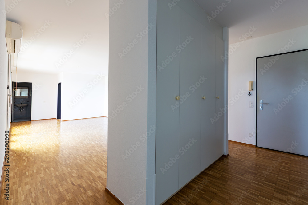 Large empty room with white walls and 70's parquet Large empty room with white walls and 70's parquet