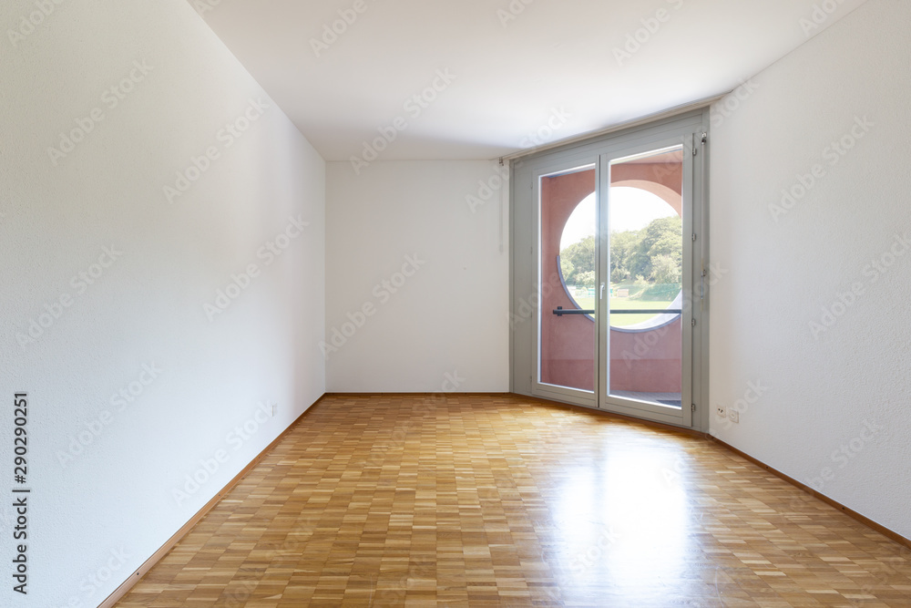 Empty room with white walls and window with balcony. Empty room with white walls and window with balcony.