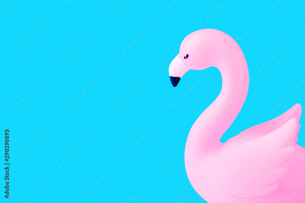 Fototapeta premium Inflatable Flamingo on a blue background, trendy summer concept, banner background with copy space.