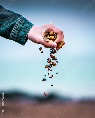 Dropping pebbles on beach