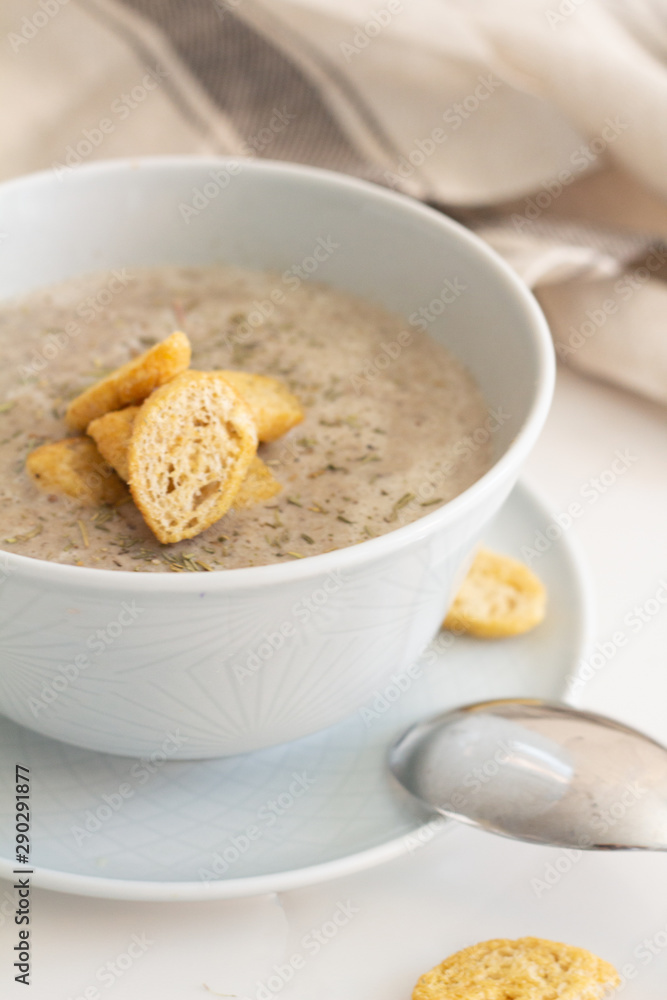 mushroom cream soup with breadcrumbs on a white plate mushroom cream soup with breadcrumbs on a white plate