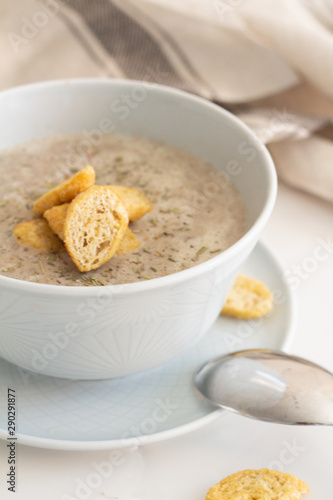 mushroom cream soup with breadcrumbs on a white plate