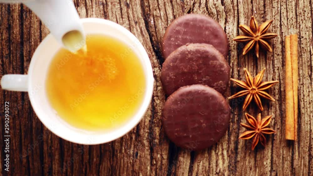 Tea composition with spices and natural herbs. A mug of tea on a textured table with cinnamon and star anise. Tea composition with spices and natural herbs. A mug of tea on a textured table with cinnamon and star anise.