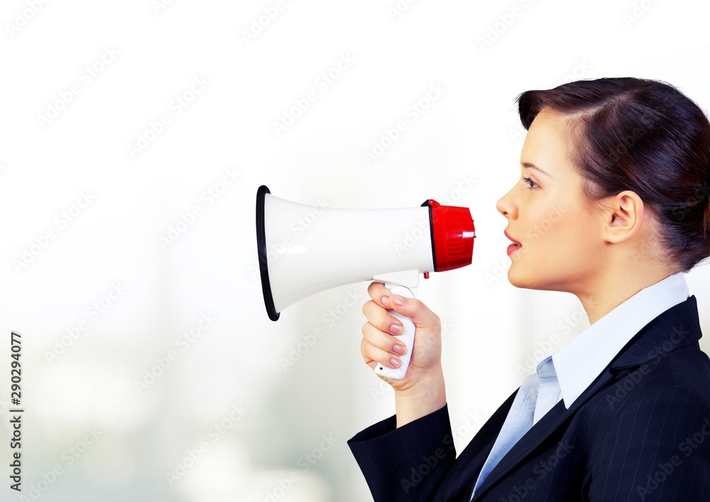 Portrait of woman holding megaphone, dressed in pin-up style Portrait of woman holding megaphone, dressed in pin-up style