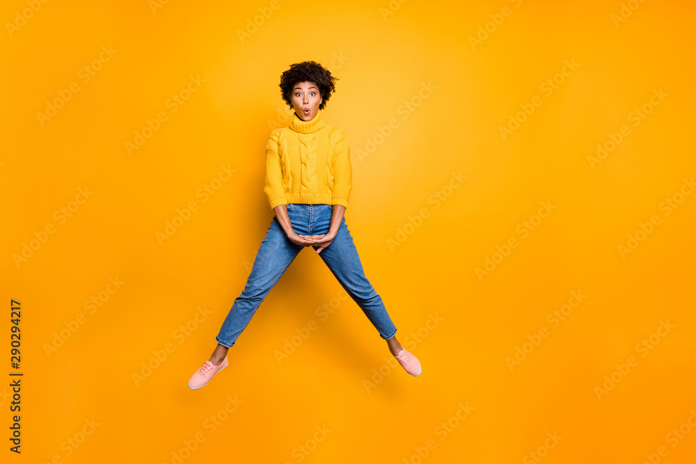 Full length body size photo of cheerful charming pretty cute sweet girlfriend wearing jeans denim footwear jumper jumping up with lips pouted isolated vivid color background