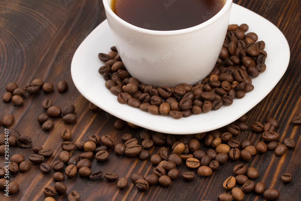Cup of coffee surrounded by coffee beans. Cup of coffee surrounded by coffee beans.