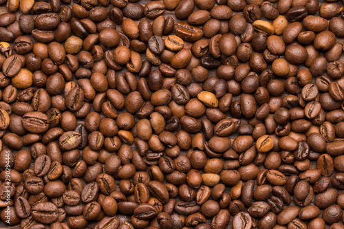 Roasted coffee beans background. Top view. Space for text.