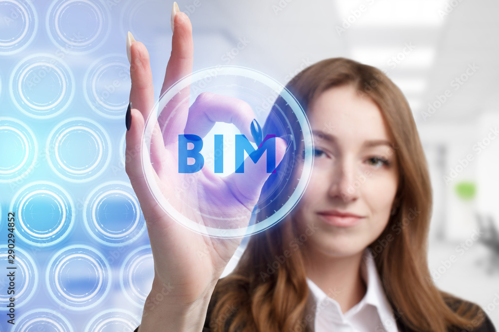 The concept of business, technology, the Internet and the network. A young entrepreneur working on a virtual screen of the future and sees the inscription: BIM The concept of business, technology, the Internet and the network. A young entrepreneur working on a virtual screen of the future and sees the inscription: BIM