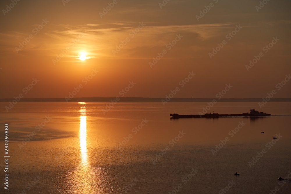 Dawn early in morning over wide long Volga river