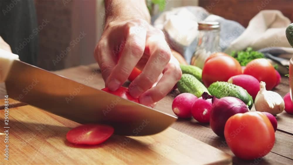 man slicing fresh tomato on cutting board prepare salad close up man slicing fresh tomato on cutting board prepare salad close up