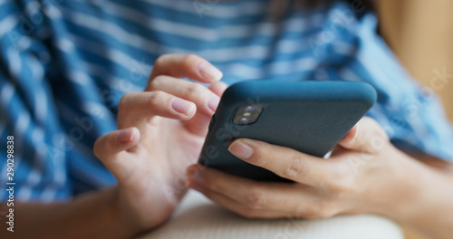 Woman use of mobile phone online at home