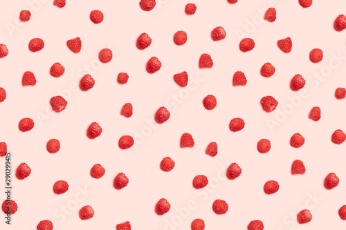 Pattern of juicy ripe raspberries on a pink background. Can be used for blog, poster or web banner.